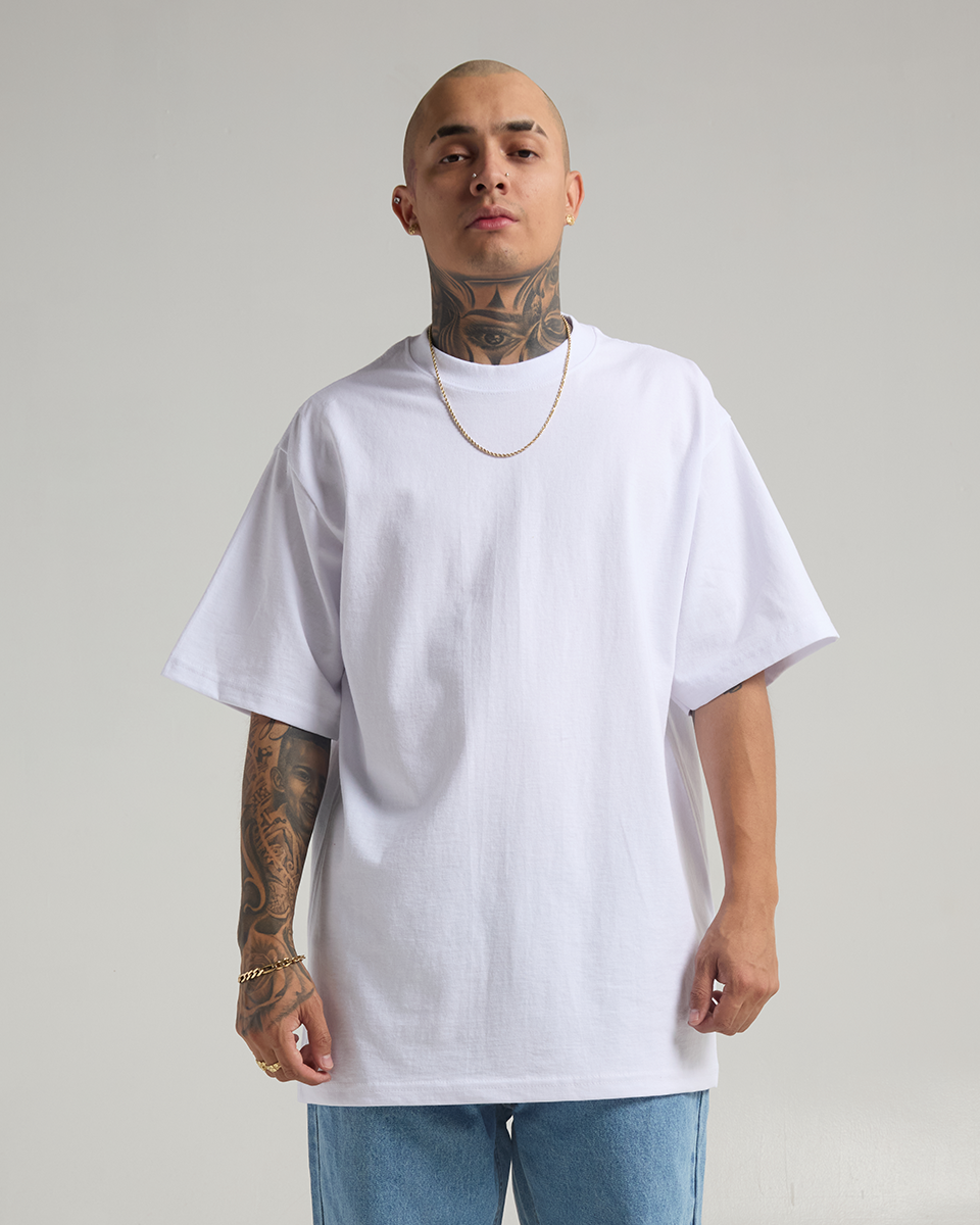 Model wearing a white Shaka Wear 7.5oz Max Heavyweight T-shirt, front view.